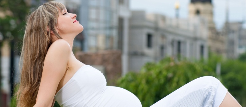 Pregnant woman sitting outdoor