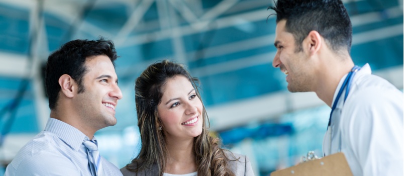 Happy couple meeting doctor