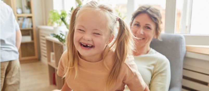 Mother playing with daughter having disability