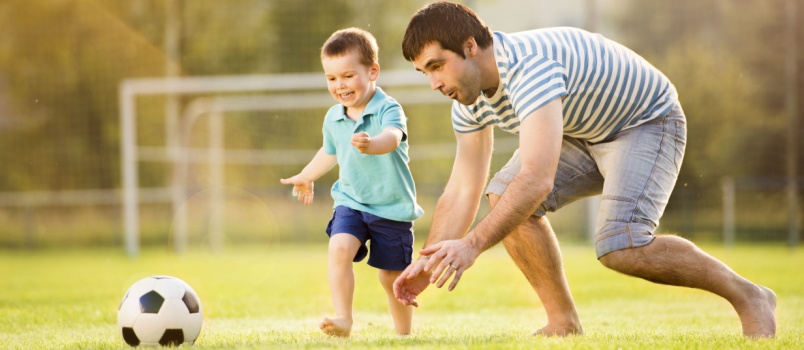 Father and son playing football