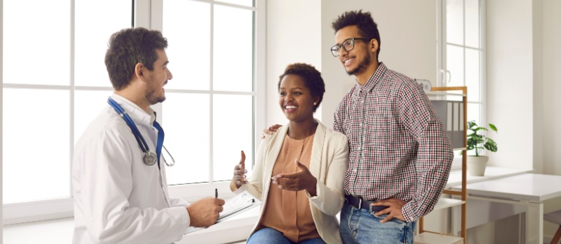 Happy couple meeting doctor