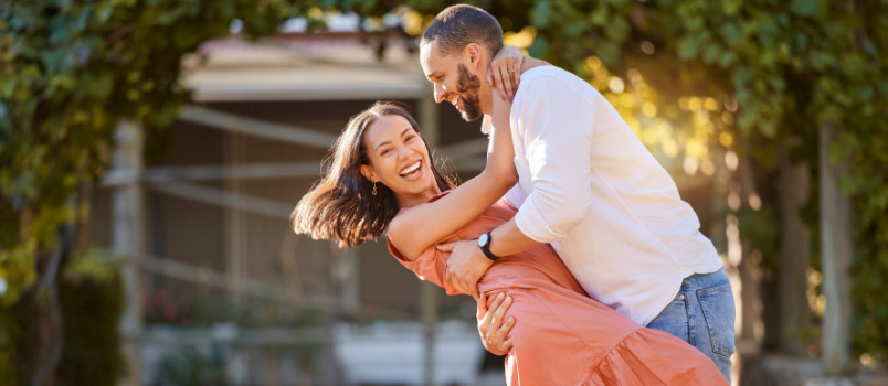 Happy couple dancing in park