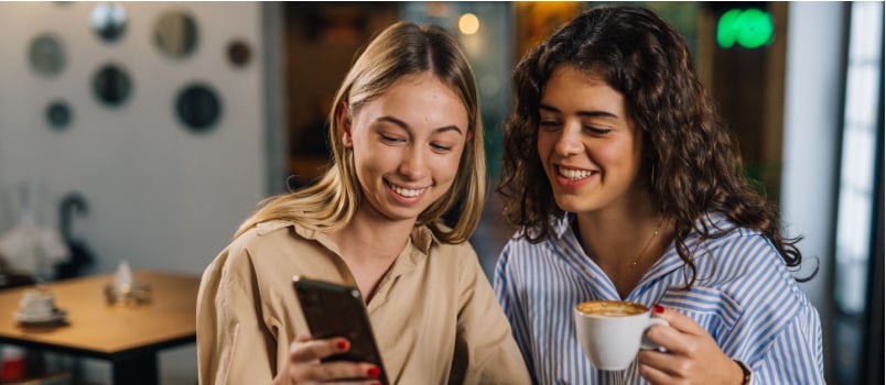 Two woman looking at phone