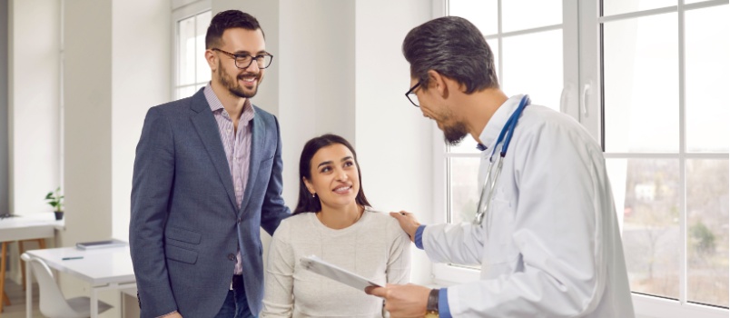 Married couple listening to doctor