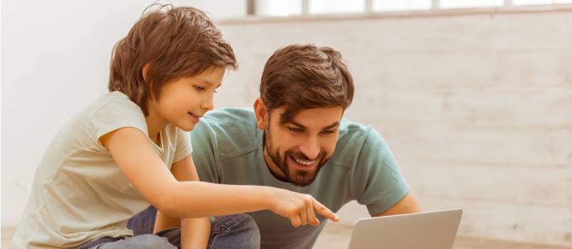Father and son using laptop