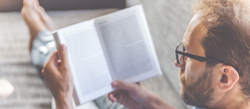 Relaxed man reading book