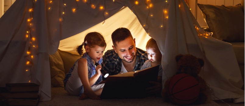 Dad and kid reading book