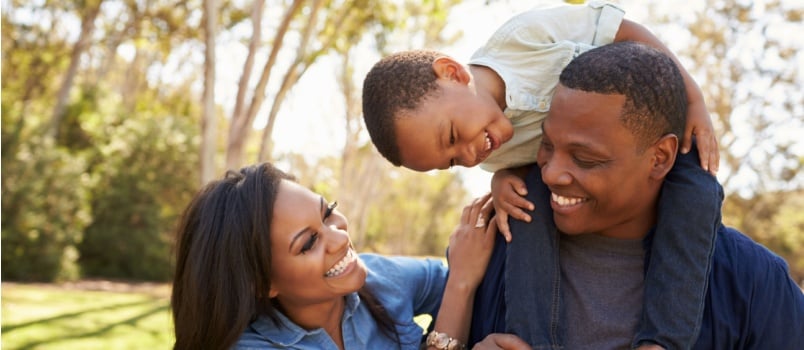 Parents carrying son on shoulder