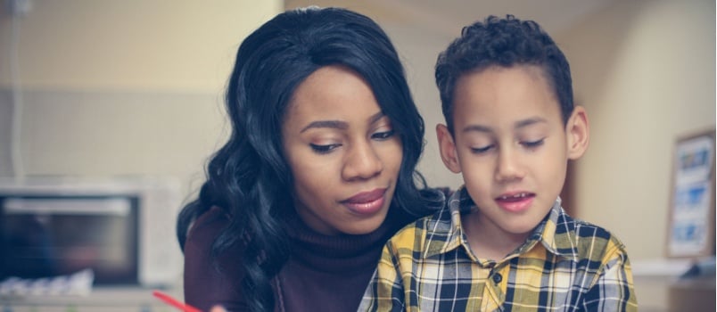 Woman and son reading book