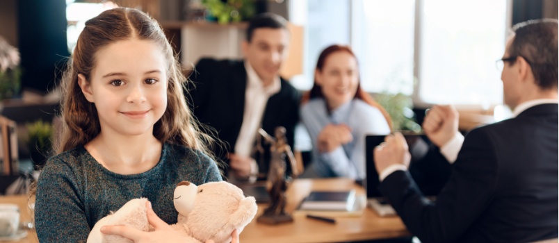 Little girl hugging teddy bear