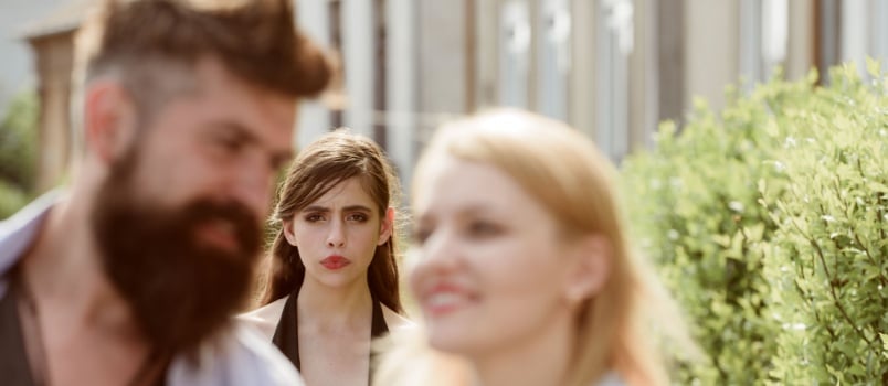 Woman is being jealous looking at couple