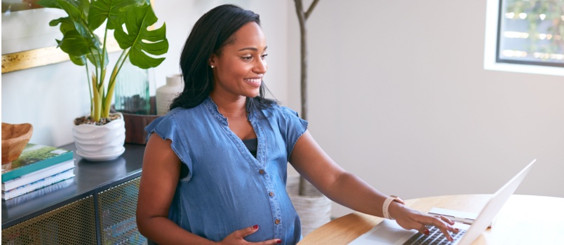 Pregnant woman using laptop