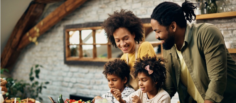 Parents and kids are working in kitchen together
