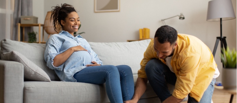 Man helping his pregnant wife