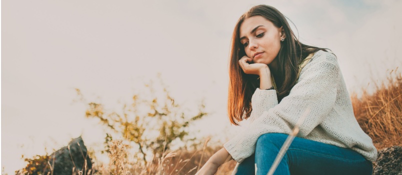Sad girl sitting alone