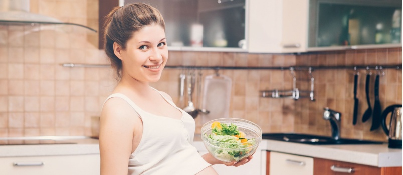 Pregnant woman cooking food
