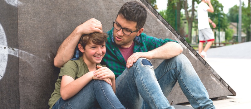 Dad and son sitting talking to each other