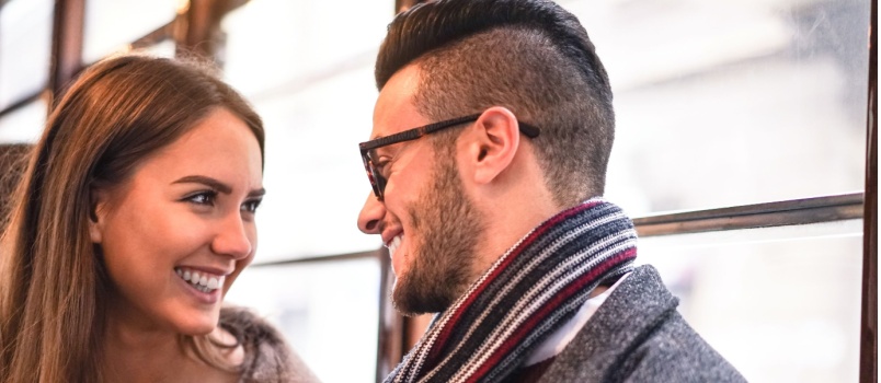 Happy couple laughing while looking at each other