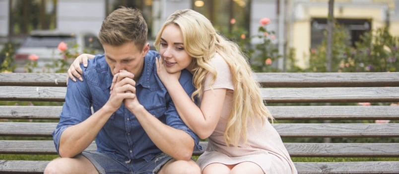 Woman comforting sad man