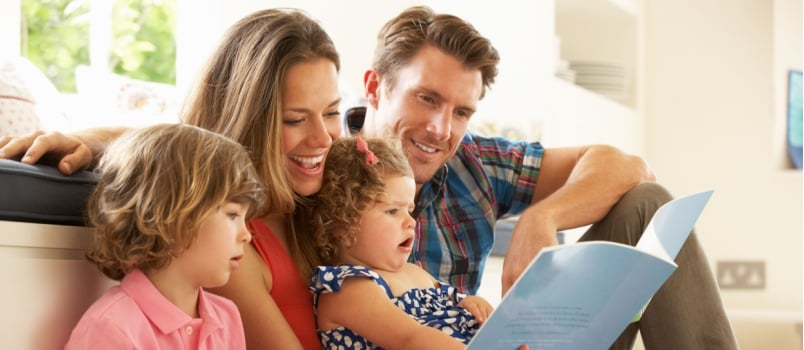 Happy family reading book together