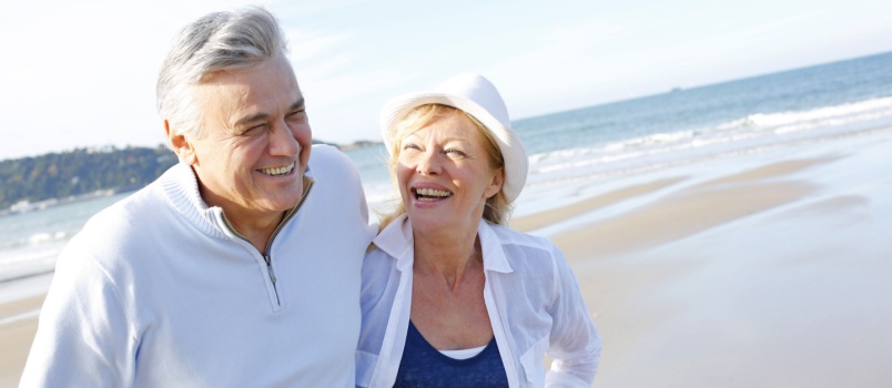 Senior couple walking on beach