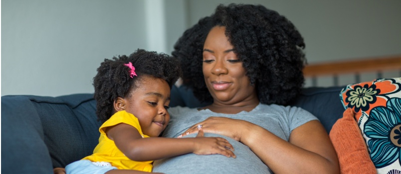 Little girl holding her mother's womb