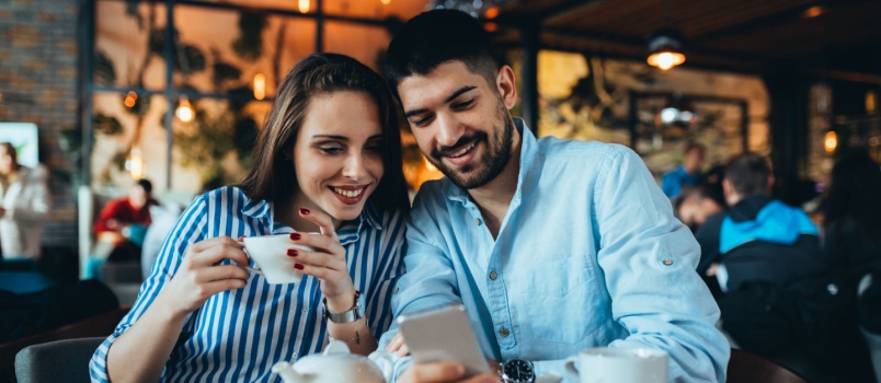 Happy couple using smartphone