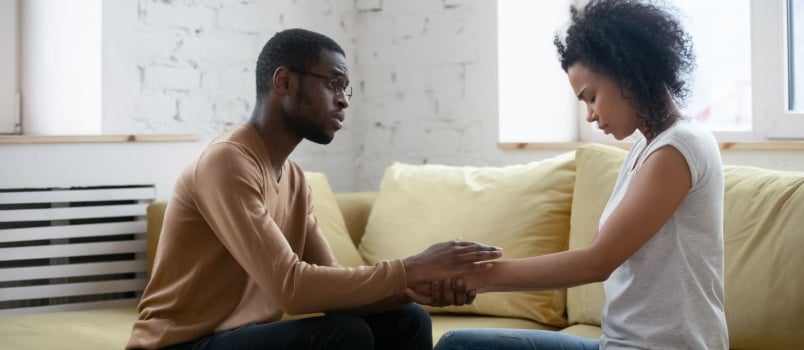 Man comforting upset woman