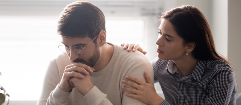 Woman comforting sad man