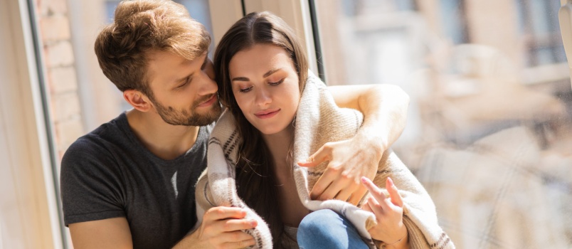 Young man hugging woman