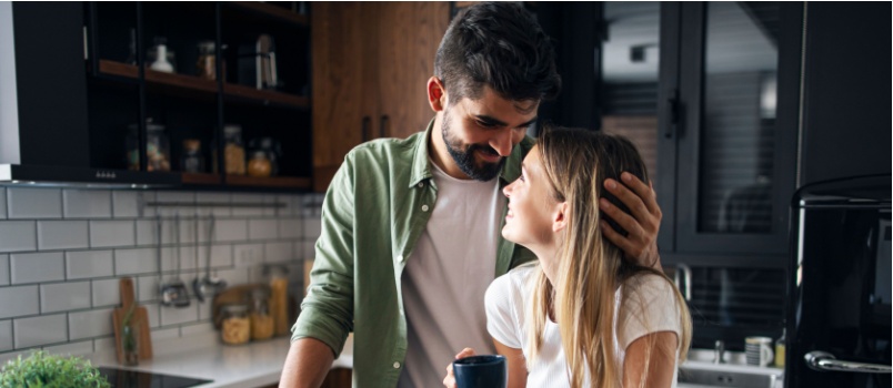 Young couple having love in kitchen