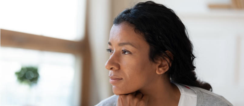 Woman looking outside of window