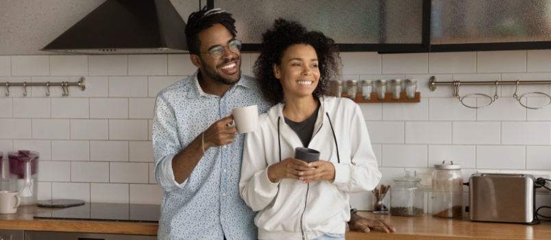 Couple having coffee in kitchen