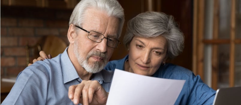 Mature couple reading letter together