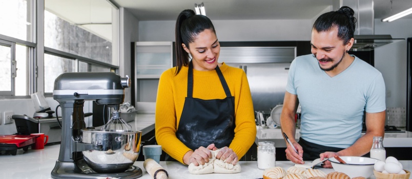 Couple bakers preparing dough