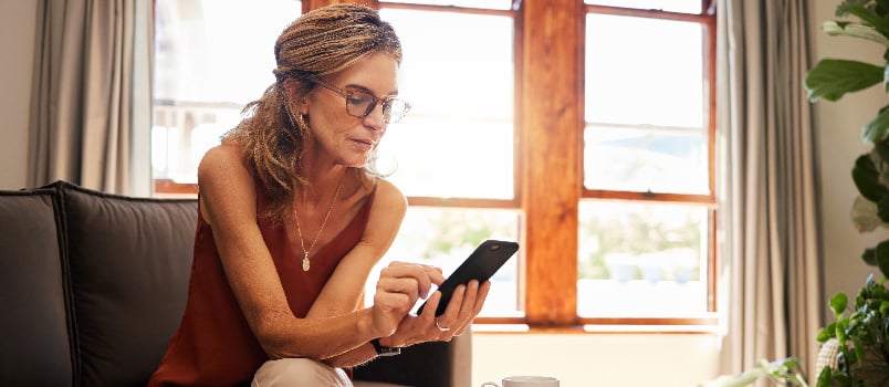 Woman sitting alone using her phone