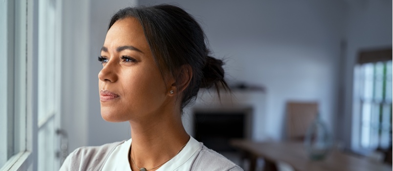Woman looking outside of window