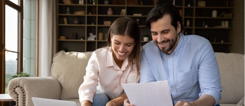 Couple signing property papers