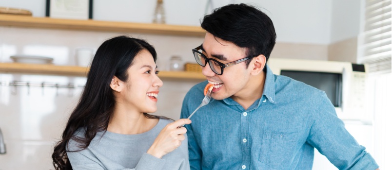 Newly wed couple having meal in kitchen