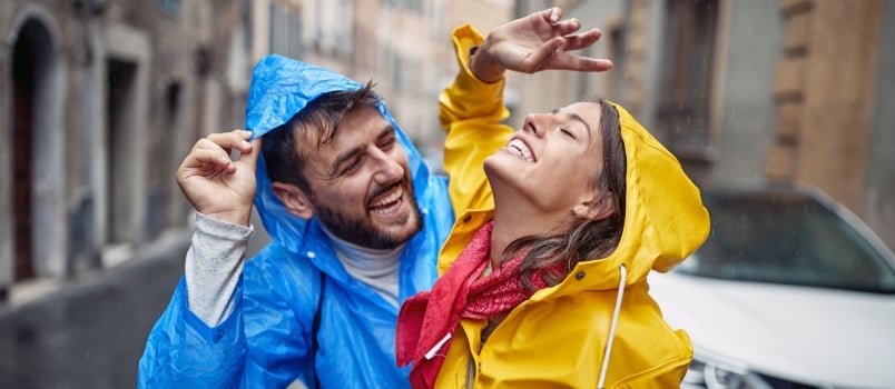 Young couple enjoying rain