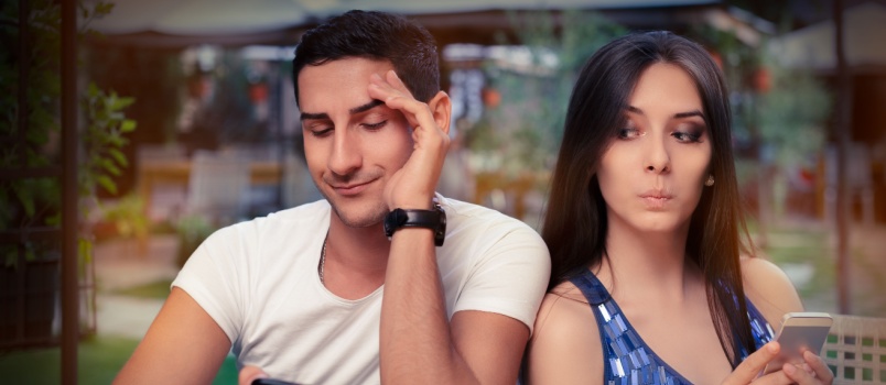 Couple busing in using their phone