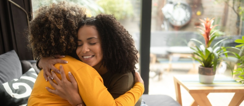 Two girls hugging each other