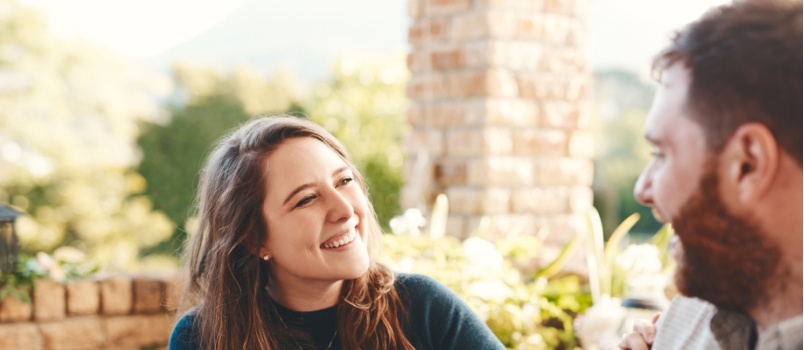 Happy couple sitting talking outdoor