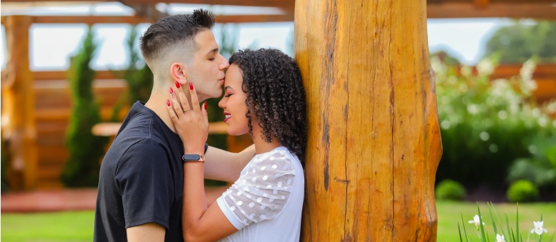 Boy kissing his girlfriend forehead