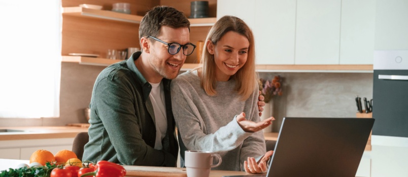 Couple sitting using laptop