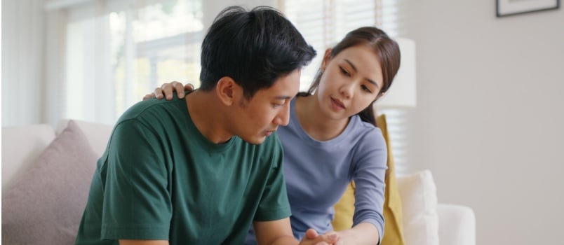 Woman comforting man