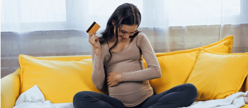 Woman happily planning finances for her pregnancy