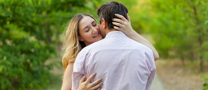 Couple hugging each other in the open