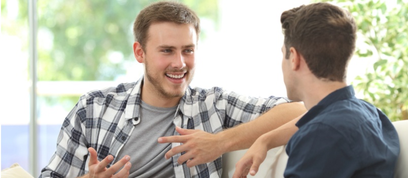 Two male friends talking to each other
