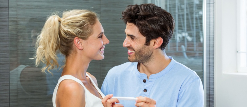 Happy couple checking pregnancy test